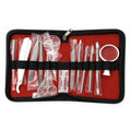 12-piece stainless steel dissection kit arranged in a black zippered case with red lining, featuring dissecting forceps, scissors, scalpel handles and blades, dissecting probes and needles, spatulas, and a magnifying glass.